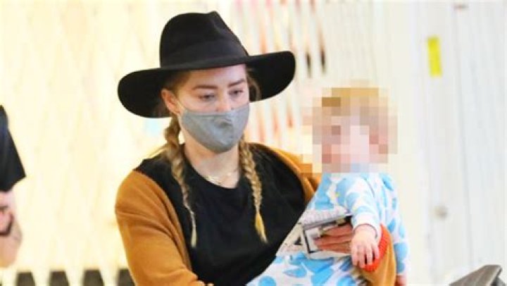 Amber Heard Cuddles Mini-Me Daughter, 10 Months, In Rare Photo