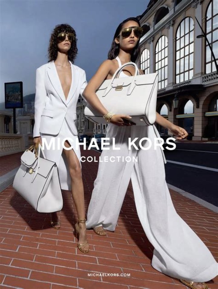 Bella Hadid Channels A ’70s Rock Star In Floral Dress & Oversized Sunglasses For New Michael Kors Campaign