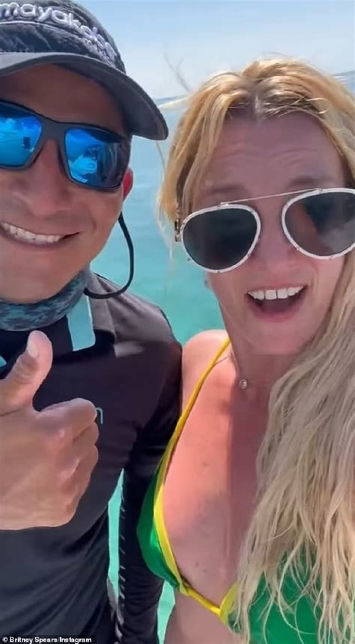 Britney Spears Stuns In Sexy Hawaiian Bikini Video As She Rolls Around In The Sand At Sunset — Watch