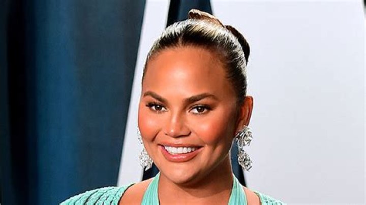 Chrissy Teigen Denies Getting Fillers As She Reveals Extremely Swollen Lips From ‘Biting An Orange’ — Watch