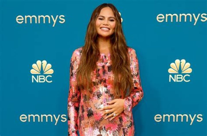 Chrissy Teigen Shows Off Her Growing Baby Bump In A Stunning Cut Out Bathing Suit