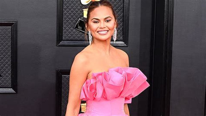 Chrissy Teigen Stuns in Black Bikini Top & Mesh Wrap On Hawaiian Spring Break Trip With Kids