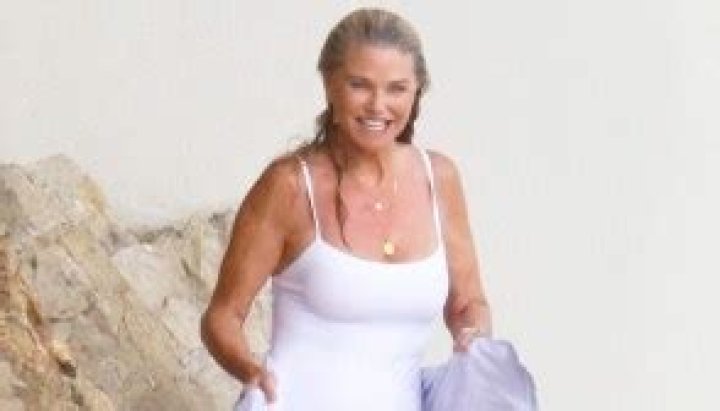 Christie Brinkley, 68, Rocks Navy Swimsuit Under White Cover-Up In New Vacation Pics