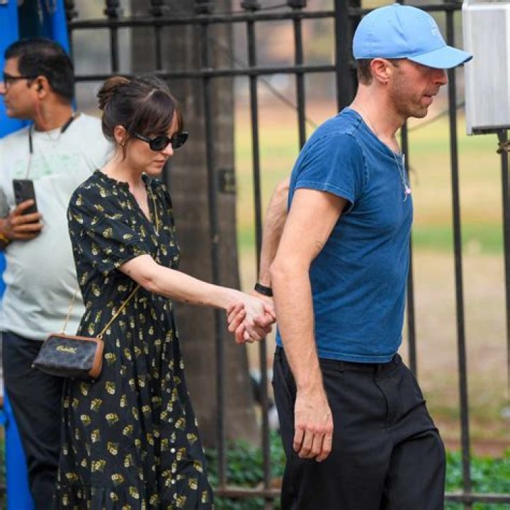 Dakota Johnson & Chris Martin Hold Hands In Rare PDA Photos After Her Movie Premiere