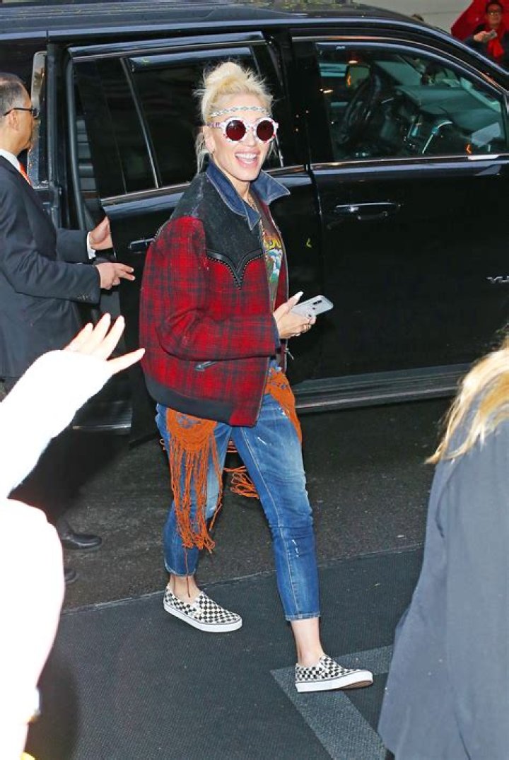 Gwen Stefani Rocks Fringe Jeans & ‘Blake’ Jacket After Arriving In NYC For Met Gala — See Pics