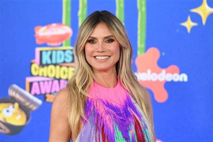 Heidi Klum, 50, Rocks Cutout Floral Swimsuit While Serving Plates Of Food On Vacay: Photos