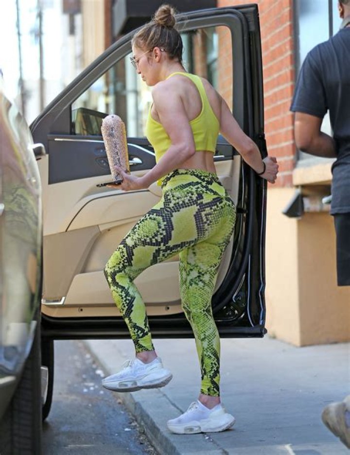 Jennifer Lopez Rocked A Crop Top & Neon Leggings & You Can Shop Her Exact Pants Under $100