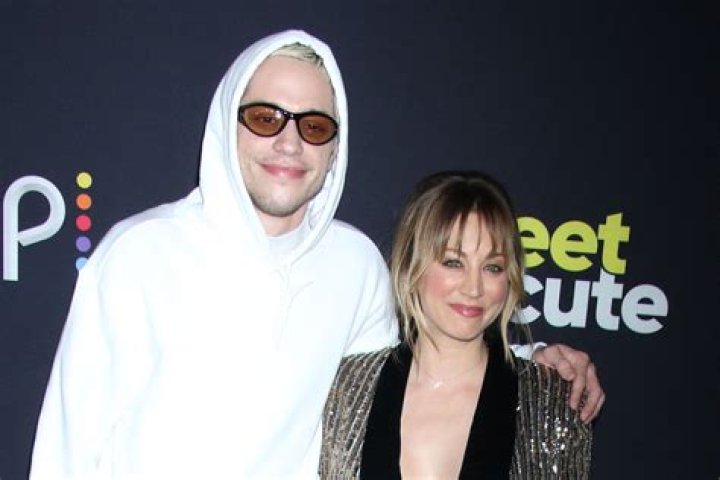 Kaley Cuoco Cradles Pete Davidson’s Face In Sweet Photos From Their Movie ‘Meet Cute’