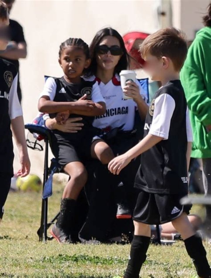 Kim Kardashian Cuddles Daughters North & Chicago While Cheering On Saint At His Soccer Game