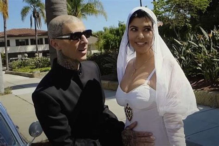 Kourtney Kardashian & Travis Barker Caught ‘Making Out’ While Watching A Stranger’s Wedding