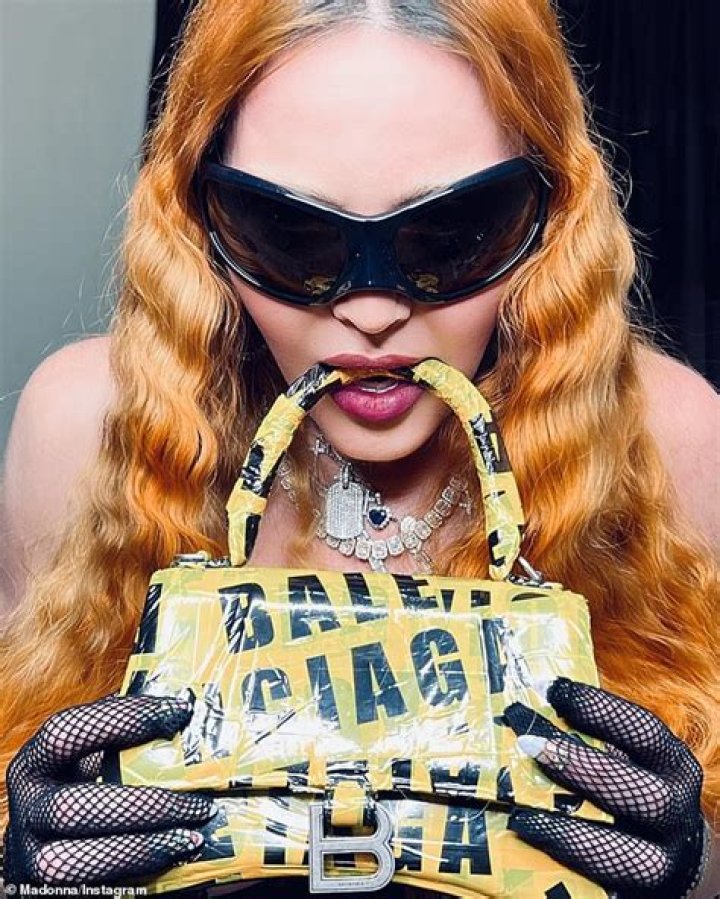 Madonna Poses Topless In New Bathroom Photos As She Bites On $3K Balenciaga Purse