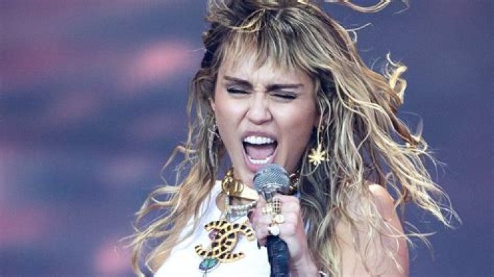 Miley Cyrus Slaps Her Bedazzled Backside In Bright Orange Outfit On NYE: ‘New Year Same Me’