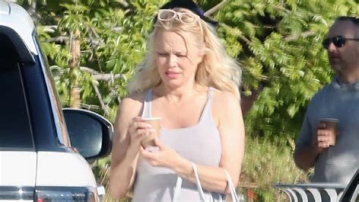 Pamela Anderson, 54, Stuns In White Dress & Knee High Boots After Divorce From Fifth Husband