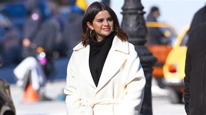Selena Gomez Braved The NYC Cold In A Chic White Wrap Coat & You Can Shop A Similar Look For Under $100