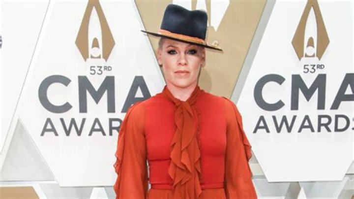 Slays In Orange Ruffled Dress & Fedora – Hollywood Life
