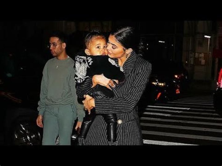 Stormi Webster, 1, Sweetly Kisses Cousin Psalm West, 8 Mos. — See Cute Photo