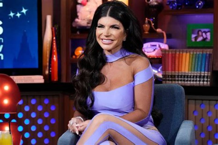 Teresa Giudice Sizzles in Plunging Purple & Green Swimsuit During Miami Getaway