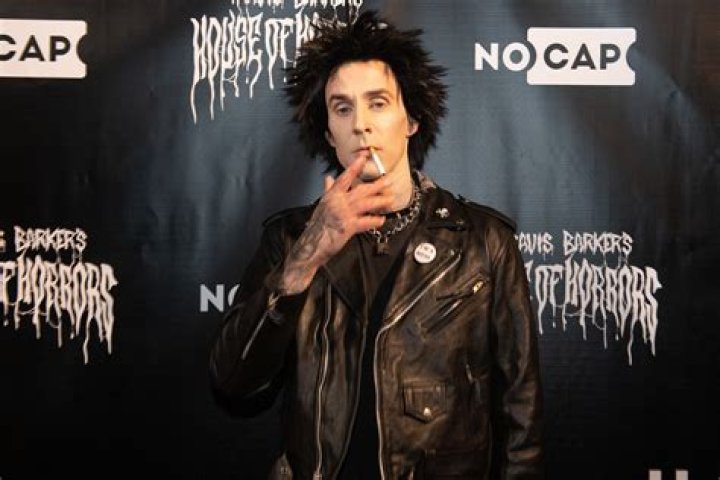 Travis Barker Looks Unrecognizable With Grey Wig & Glasses In MGK’s Music Video