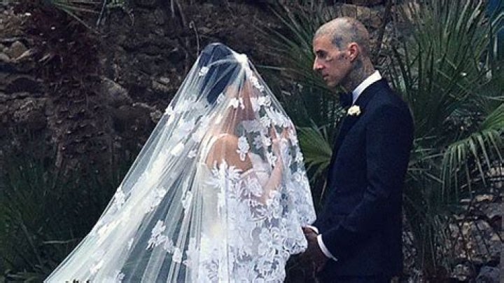 Travis Barker Removes Kourtney Kardashian’s Garter With Teeth At Wedding Reception: Watch